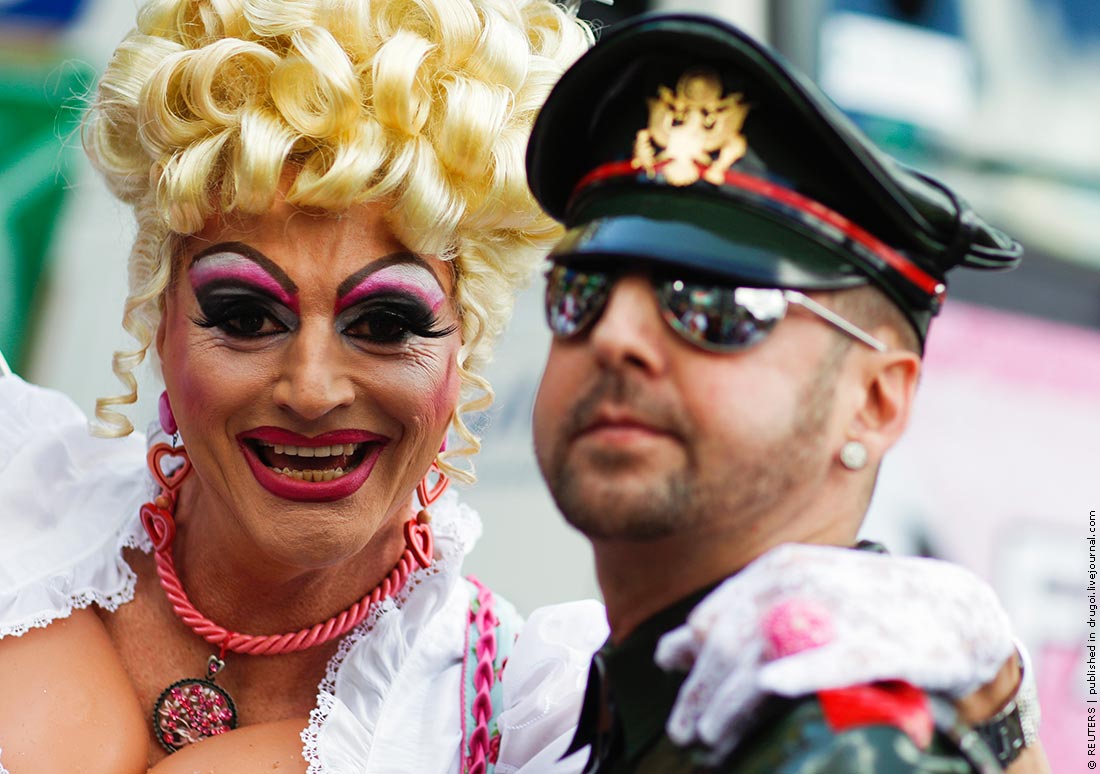 Revellers pose for pictures at the Christopher Street Day (CSD) parade in Berlin